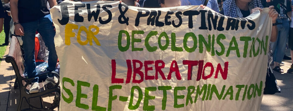 A hand-painted banner reads: "Jews & Palestinians for Decolonisation Liberation Self-determination"